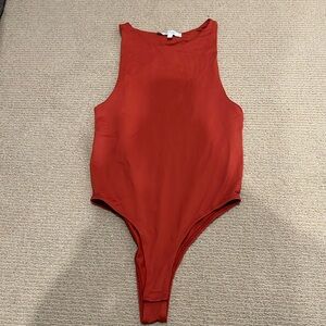 burnt orange body suit, small